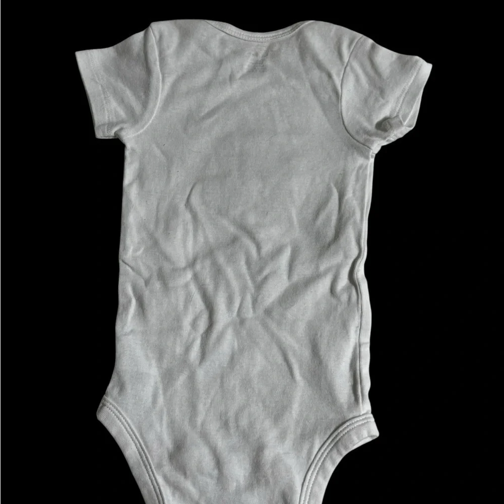 Gerber White Bodysuit with “What would Dolly Do”